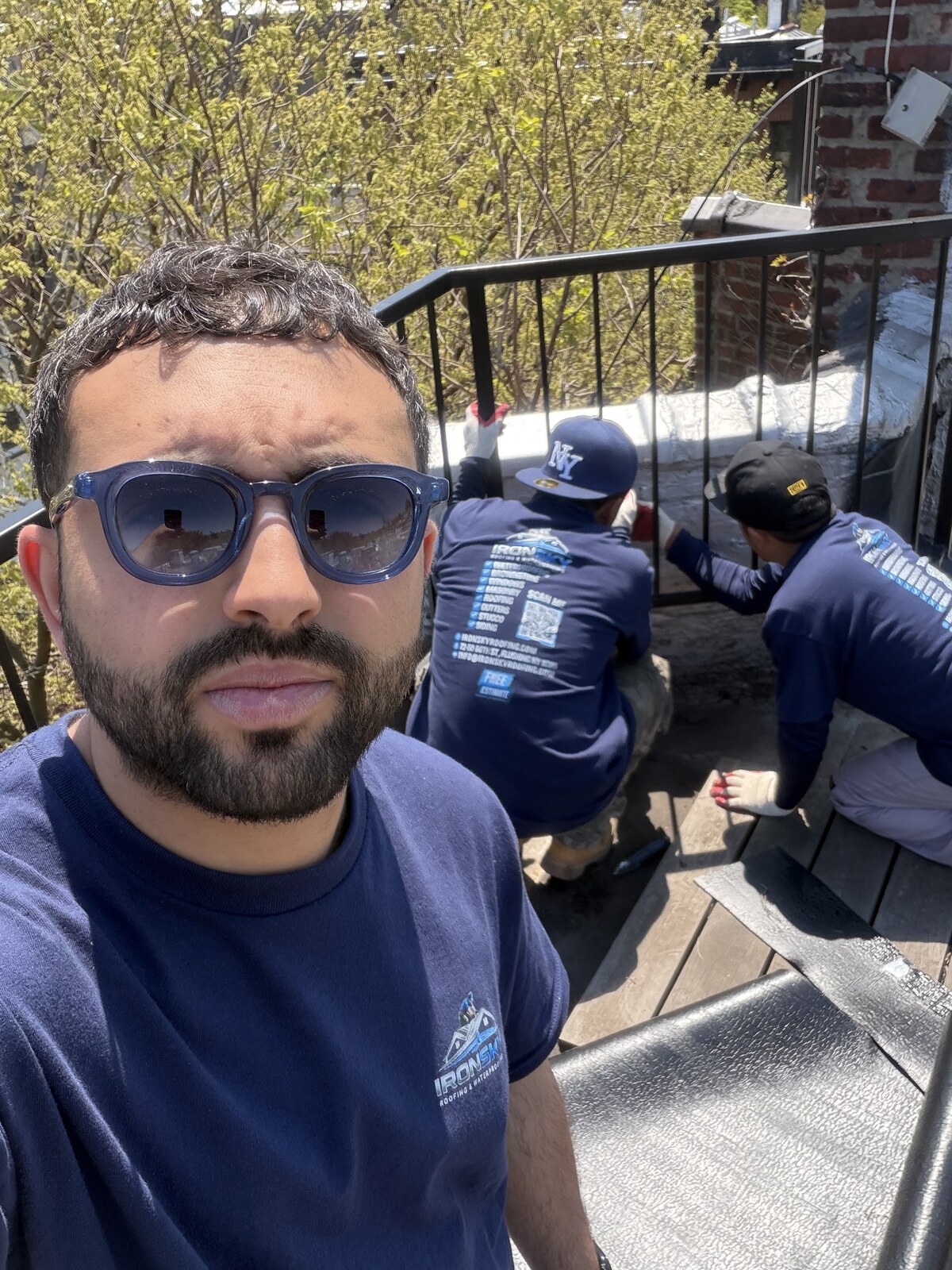 IronSky crew working on rooftop masonry and railing in NYC